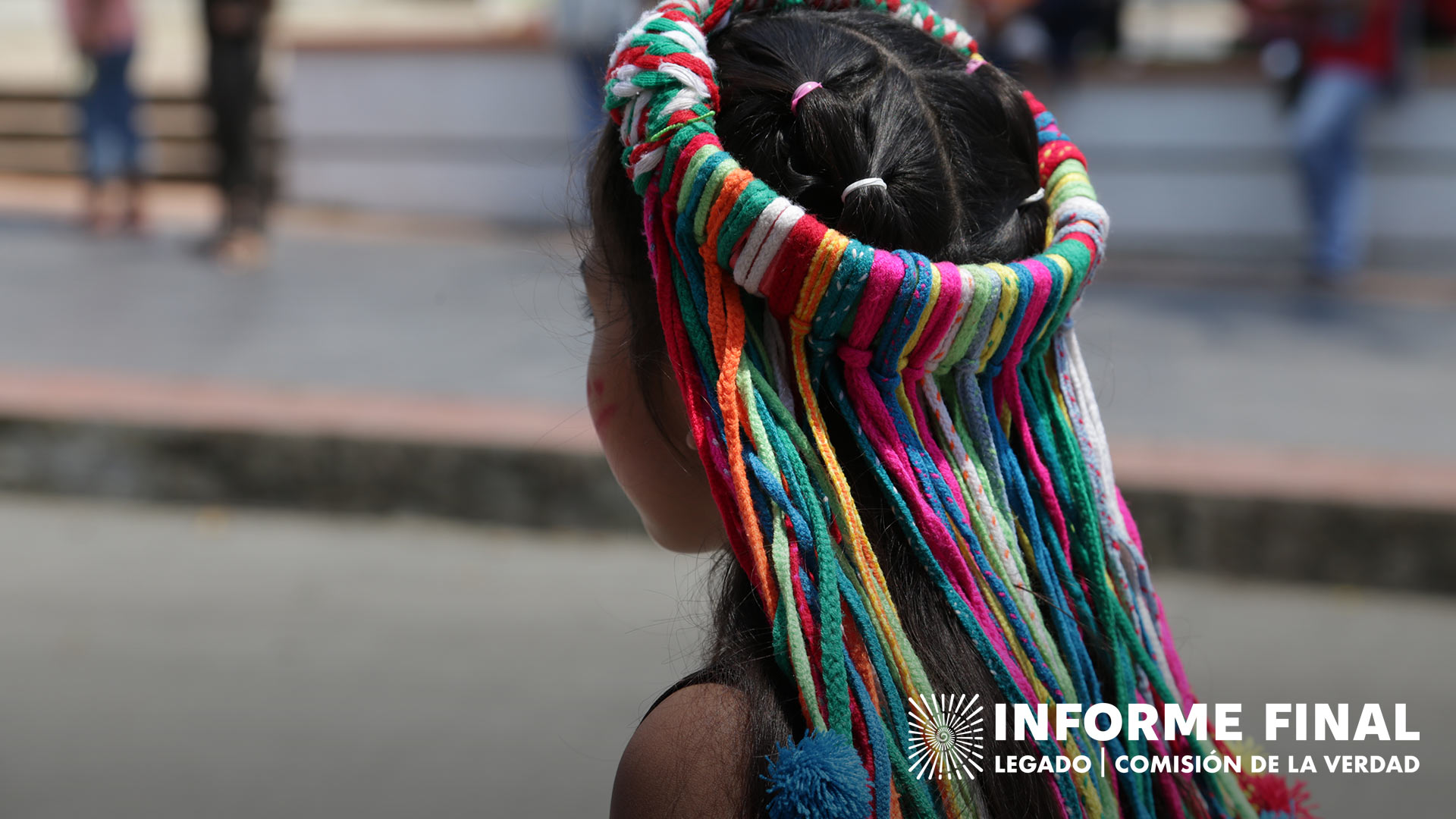 Niña con arreglo folclórico de colores en su cabeza 